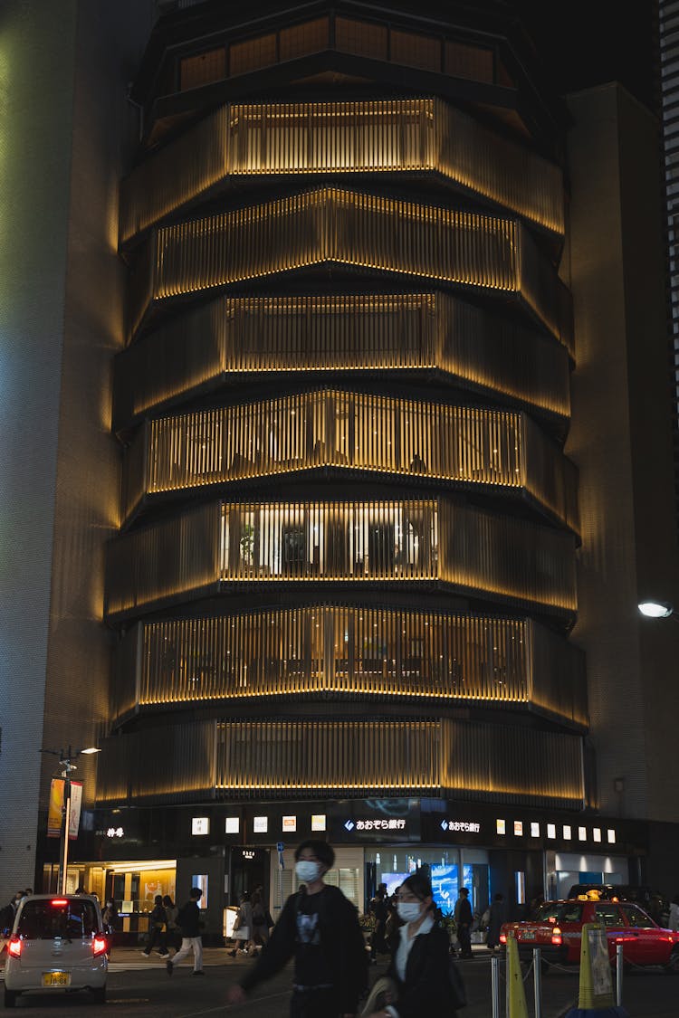 People In Masks Near Unusual Building