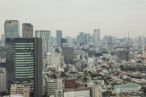 Free Aerial view of modern city with glass skyscrapers and multistory buildings in overcast weather Stock Photo