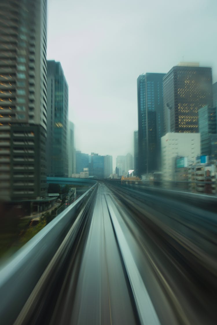 Empty Highway Going Through Modern Skyscrapers On Cloudy Day