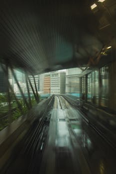 A dynamic view of Tokyo's railway illustrating speed and urban architecture.