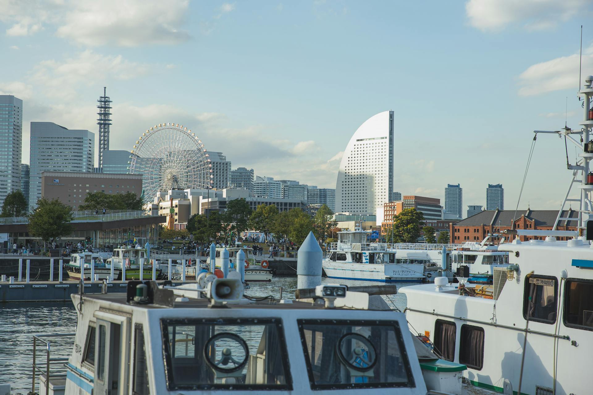 Vessels moored in harbor of modern urban city