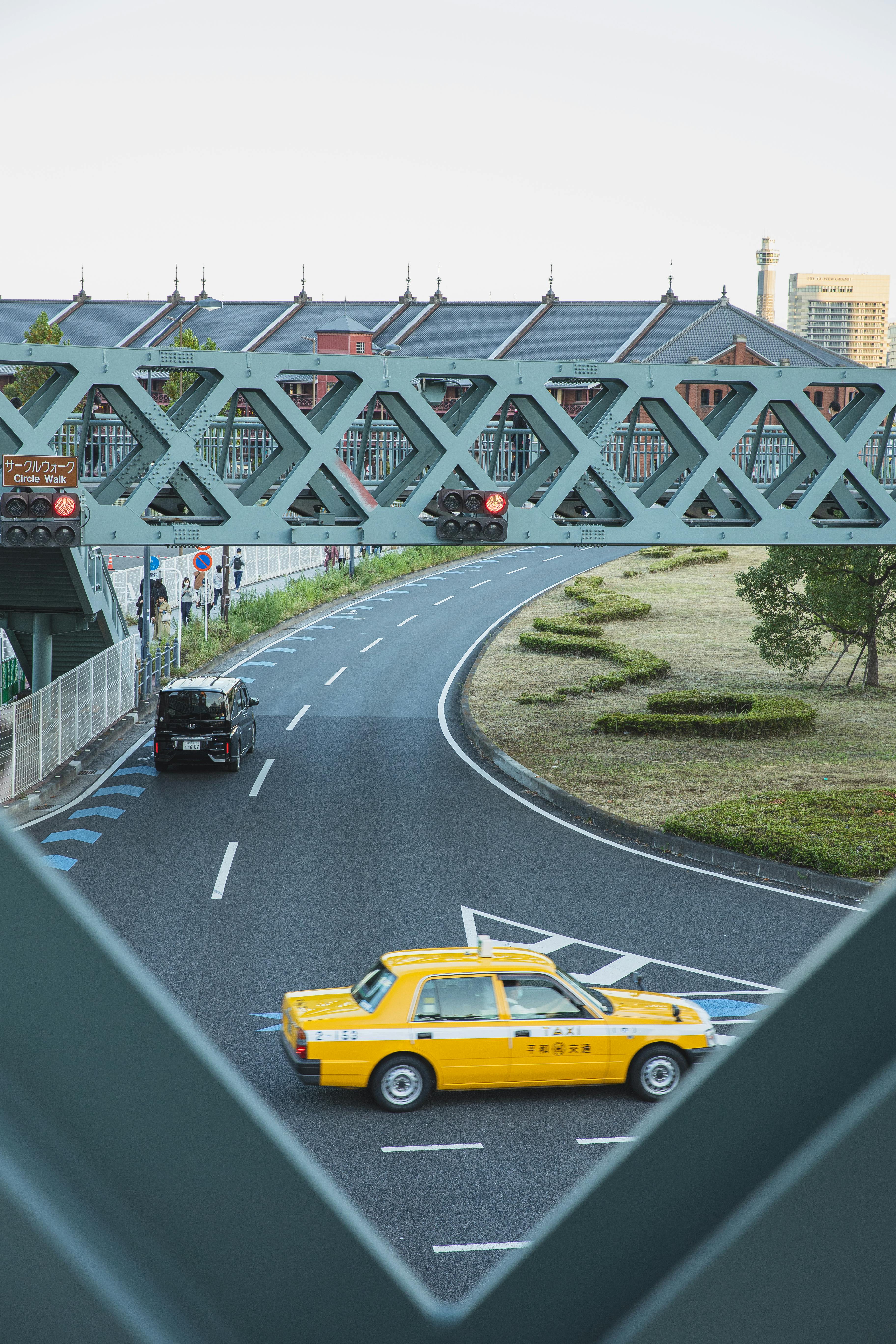 asphalt road under pedestrian overpass in modern city