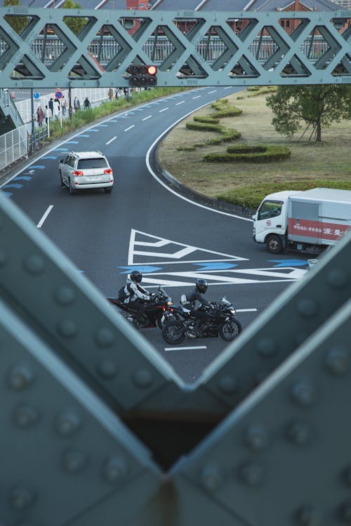 Vehicles driving on asphalt road in city