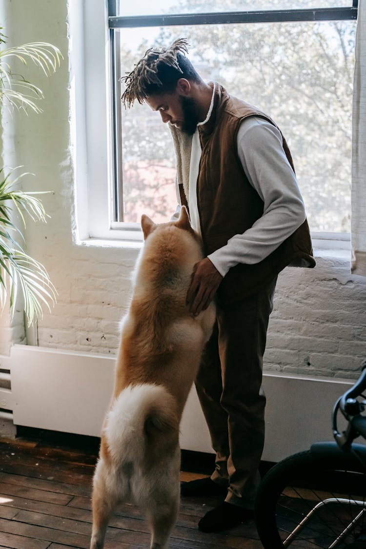 Stylish Black Guy Playing With Cute Dog