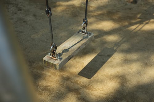 Metal and wooden swing in park