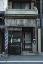 Old shabby abandoned building of barbershop on street