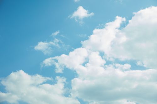 Free From below of blue sky with white thick clouds in bright summer day Stock Photo