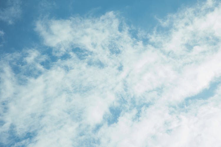 Fluffy Clouds Against Clear Blue Sky