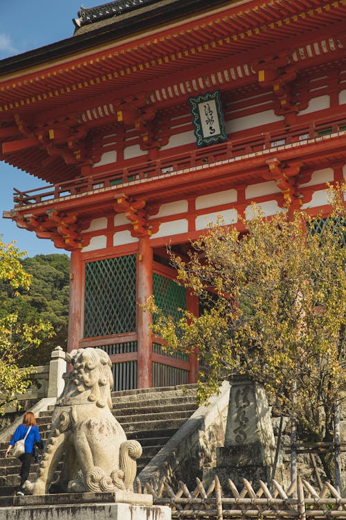 Traditional pagoda behind stone stairs and statue