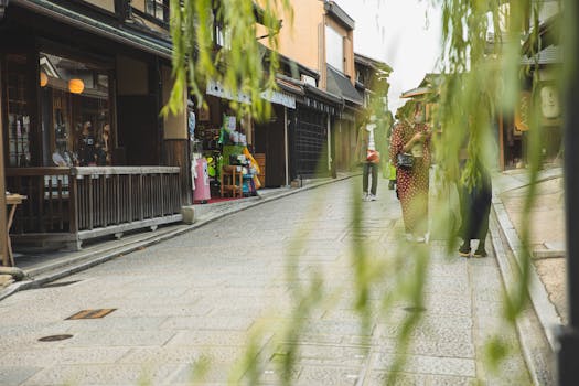 Anonymous people in masks strolling on pavement street of city with oriental constructions