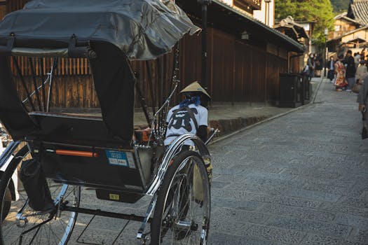 Traditional rickshaw on a cobblestone street in historic Kyoto, Japan.