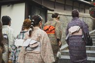 Unrecognizable Asian women walking on street