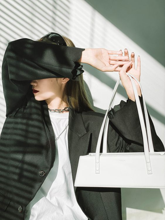 Stylish woman with handbag at sunlight · Free Stock Photo
