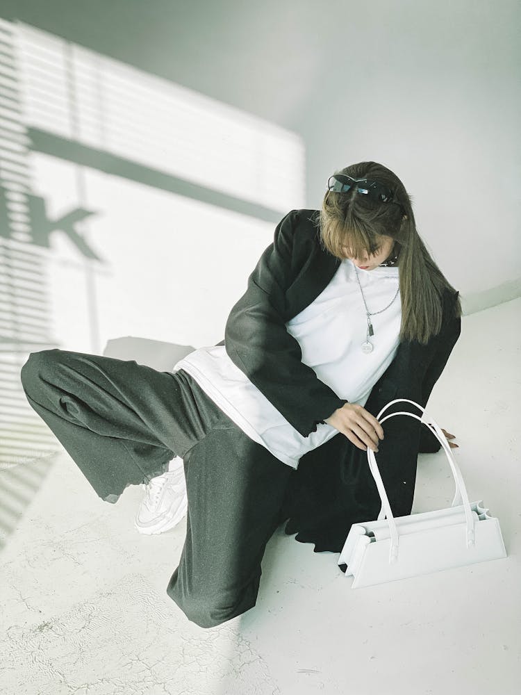 Stylish Woman In Oversize Suit With Handbag