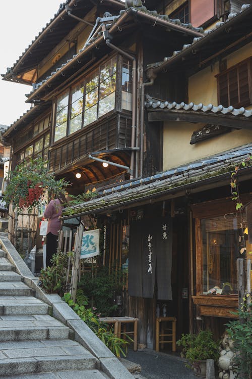 Exterior of oriental wooden attached houses with typical roofs located in suburb area in Asia in daylight