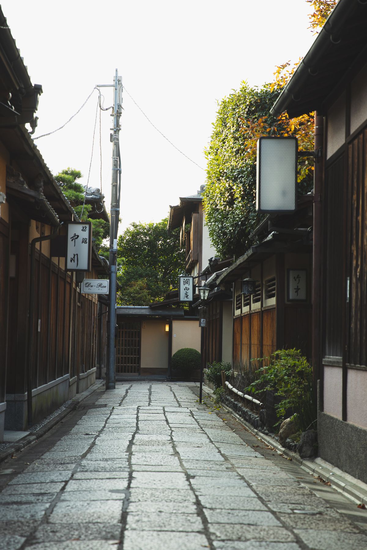 Narrow alley with small traditional wooden houses in Japan — illustrative of the Edo-period streetscape of Ouchi-juku in Fukushima Prefecture