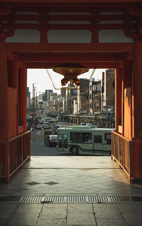 Free Through red gates of ancient Yasaka Shrine of various vehicles driving on road in Kyoto district Stock Photo