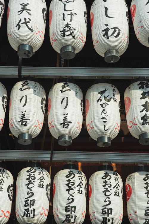 Row of traditional Japanese lanterns decorating exterior of ancient shrine