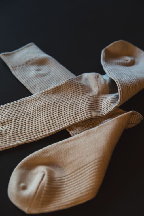Folded cream ribbed socks — photo by Ryutaro Tsukata on Pexels