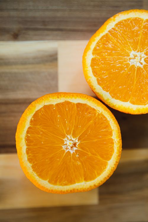 Free From above of colorful halves of ripe and tasty orange with sweet pulp in geometric segments Stock Photo