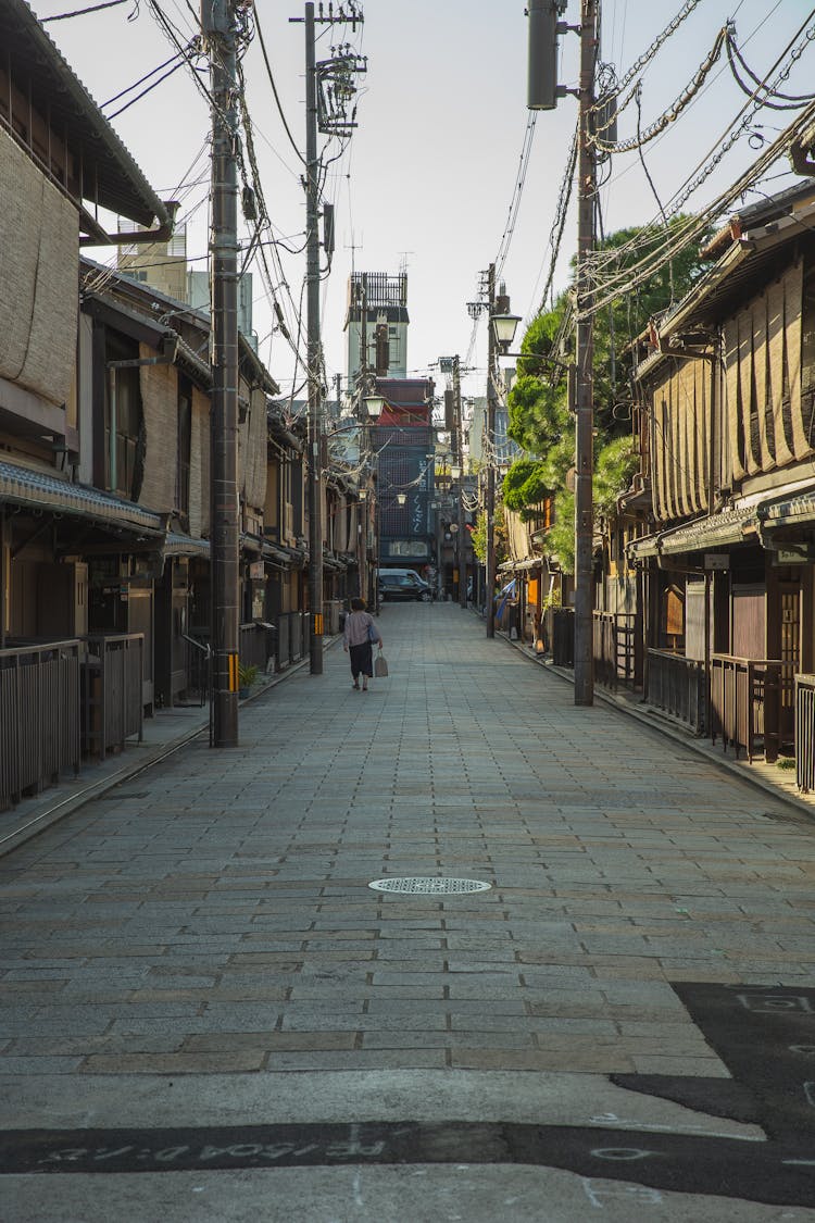 Anonymous Female Walking On Kyoto Street In Morning