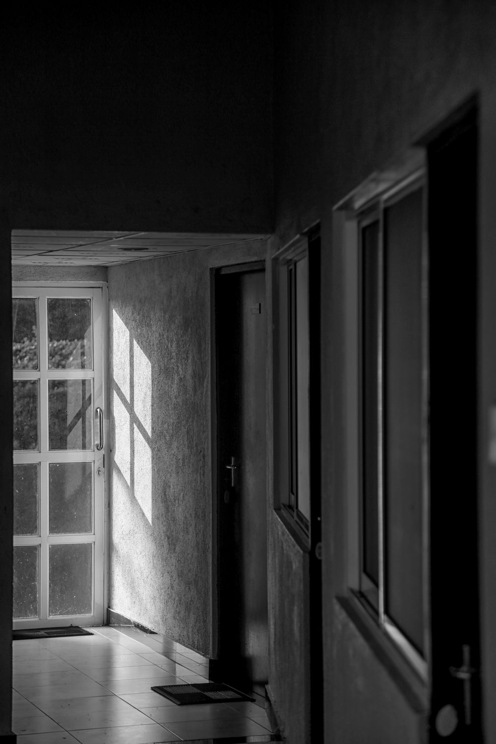 Shadowed doorway in an old stairwell, photo by Charith Kodagoda on Pexels