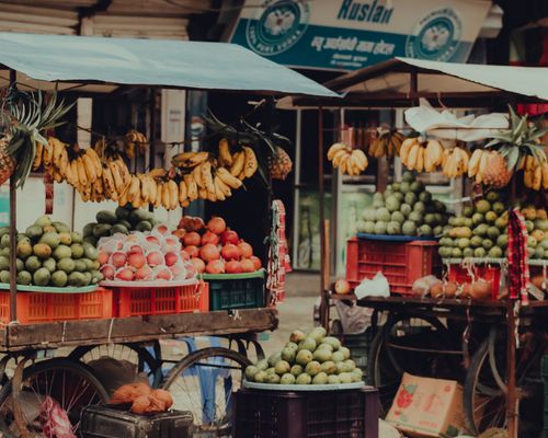 Free Colorful fruit stand at a vibrant street market in Butwal, showcasing bananas, mangoes, and pomegranates. Stock Photo