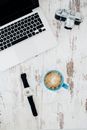 Silver and Black Camera; Silver and Black Laptop; Blue Ceramic Mug
