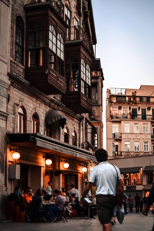Free City district with old residential buildings and cafe with terrace on street in daytime Stock Photo