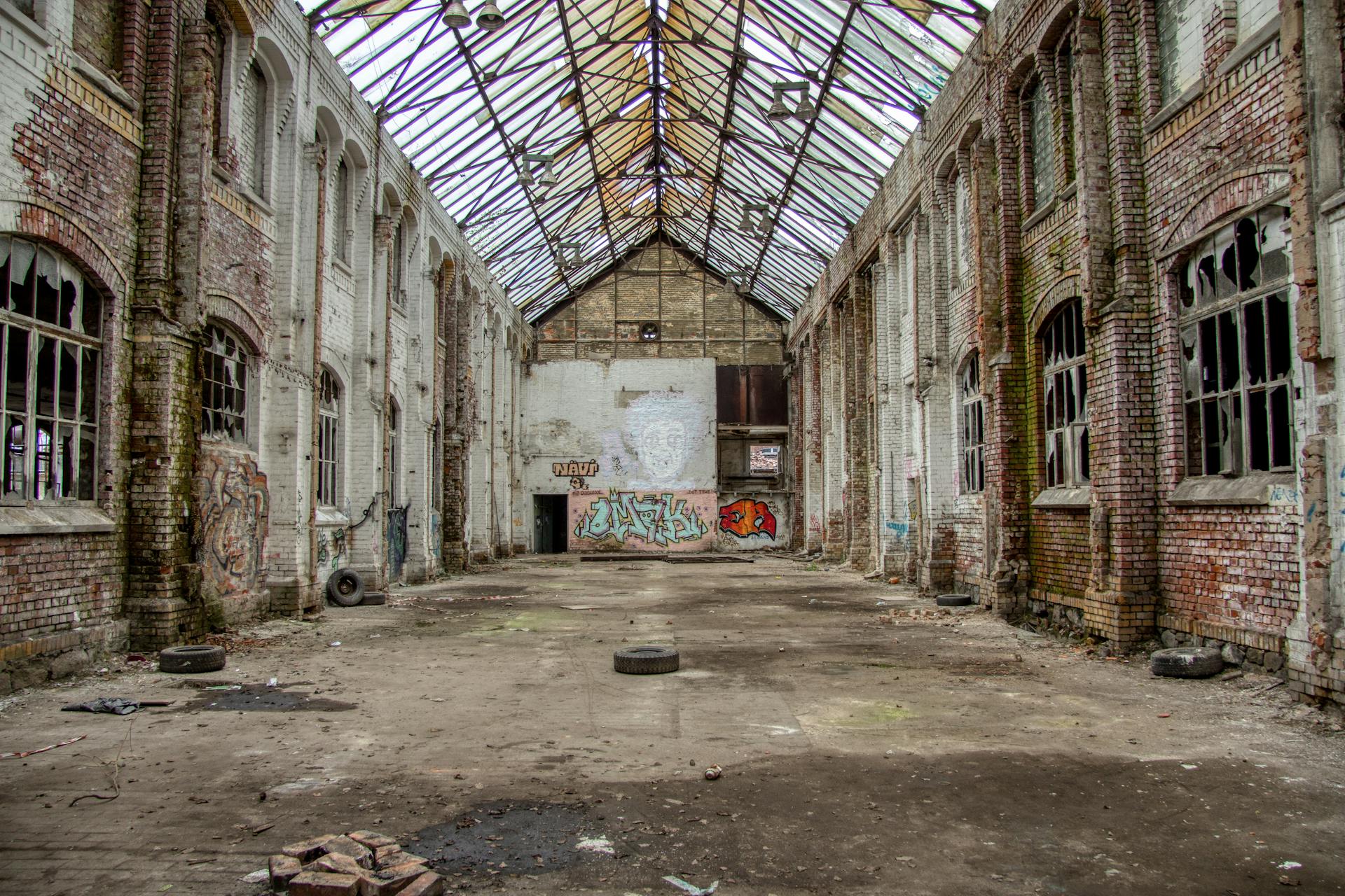 Spacious graffiti-covered abandoned warehouse interior in Leipzig, Germany.