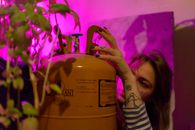 Woman with refrigerant and green plant