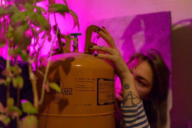 Woman With Refrigerant And Green Plant