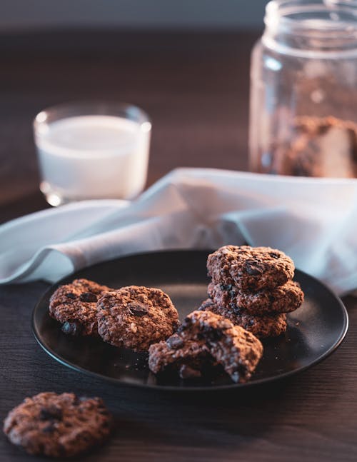 Free Pieces of Chocolate Chip Cookies on Black Plate Stock Photo