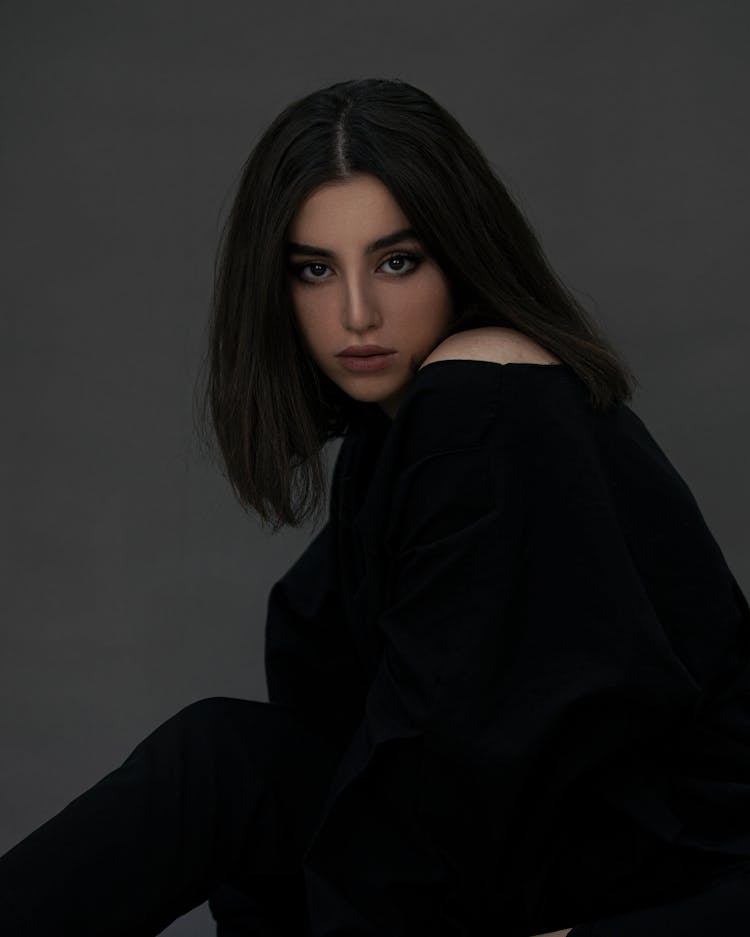 A Pretty Young Woman In Black Long Sleeve Shirt