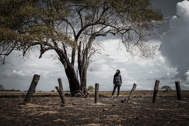 A Woman Standing Under The Tree