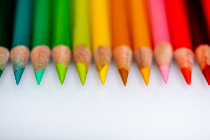 Sharpened colouring pencils lined up in order on a pale surface — photo by Skyler Ewing on Pexels