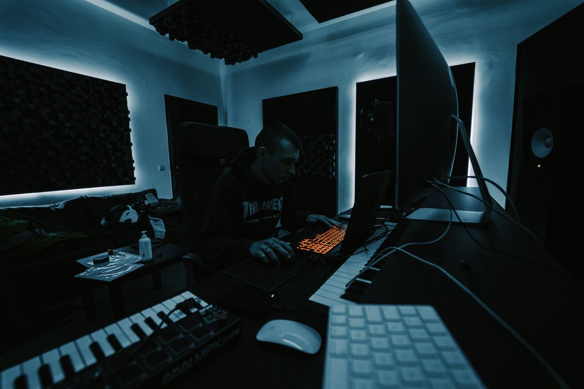 Kofi Mensah's studio lit by screens at night