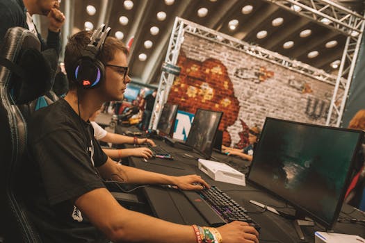A young male gamer intensely focused during an esports event at an indoor gaming convention.