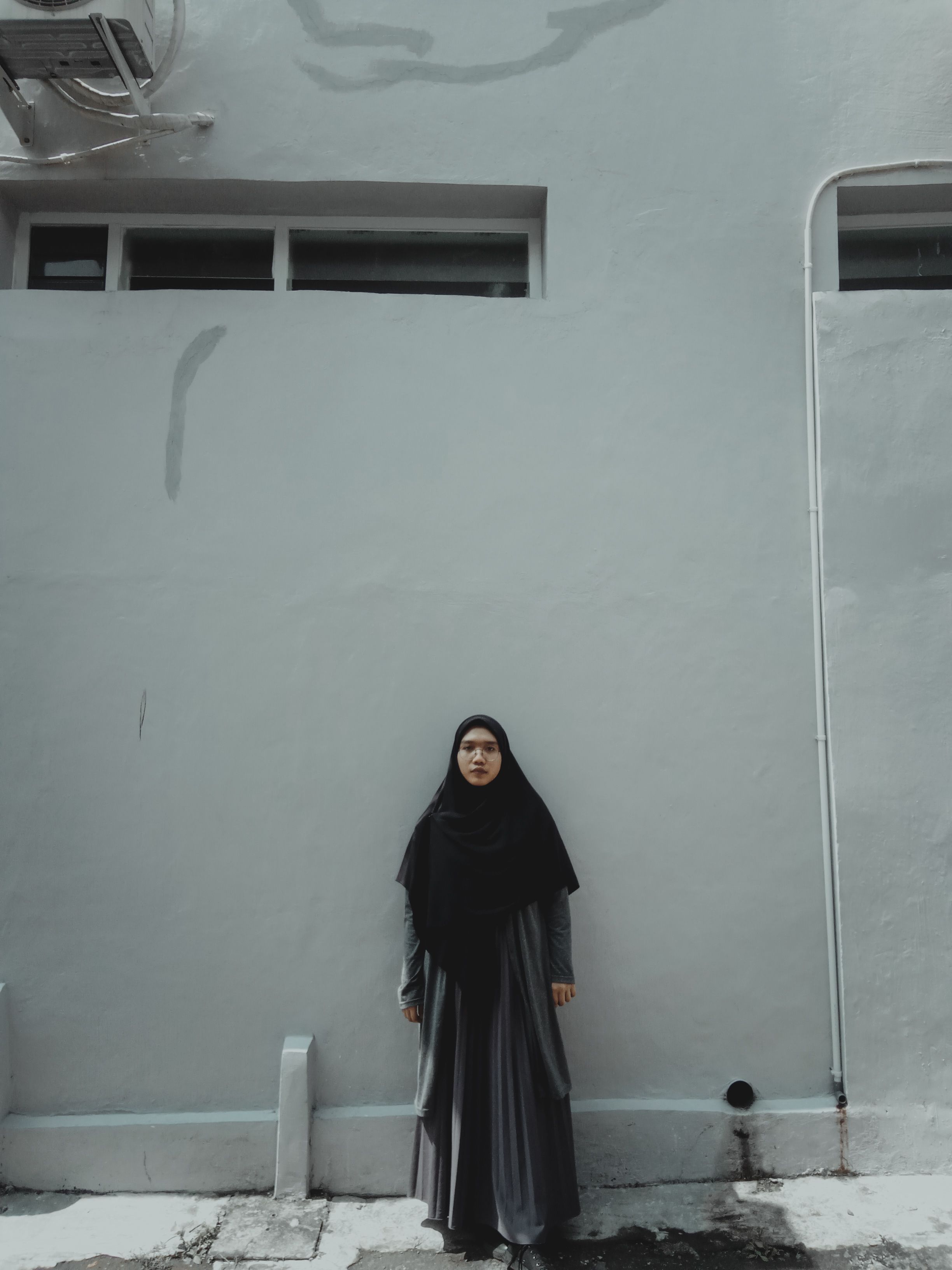 A Woman in Black Hijab Standing Beside White Wall · Free Stock Photo