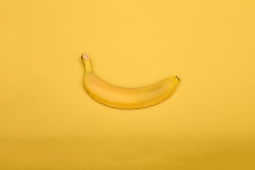 Free Yellow Banana on Yellow Background Stock Photo