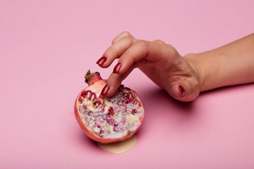 Free A Person Holding a Pink Fruit Stock Photo