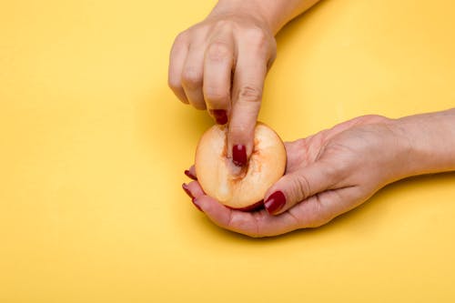 Free A Person Holding a Fruit Stock Photo