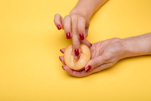 A Person Holding Sliced Fruit