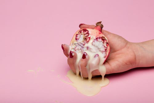 Free A Person Holding a Pink Fruit Stock Photo
