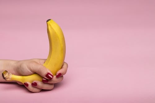 Free A Person Holding Yellow Banana Fruit Stock Photo