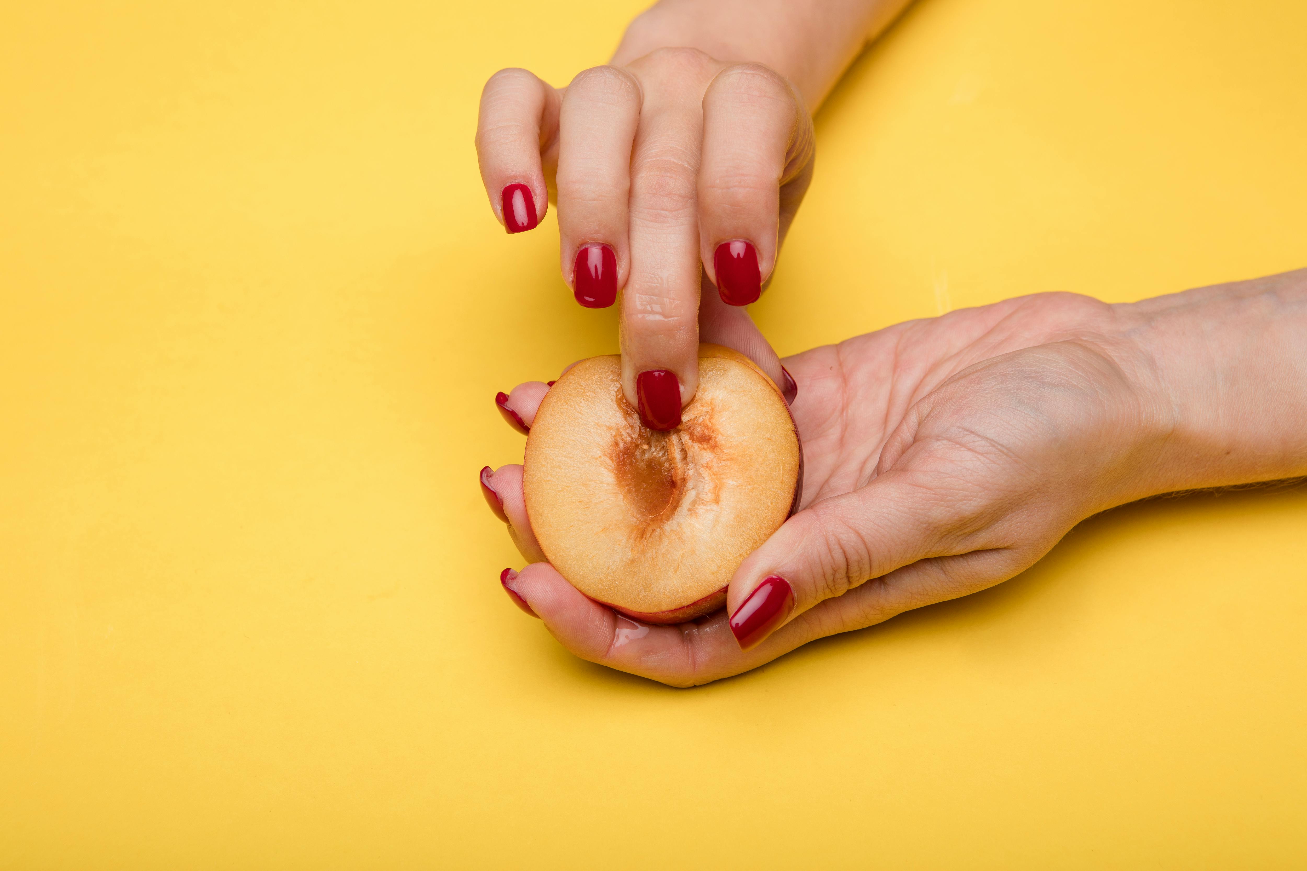 finger on sliced peach