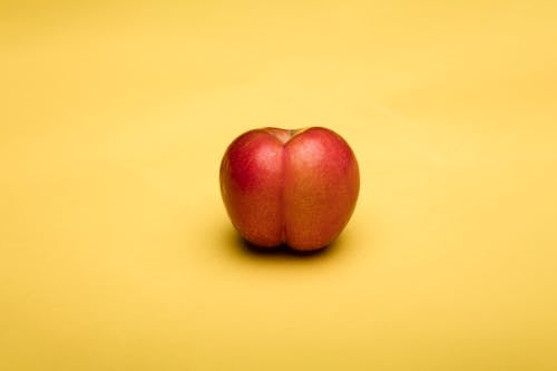 Apple on Yellow Surface
