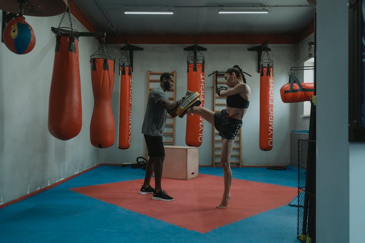 Woman Doing High Kick During Boxing Training