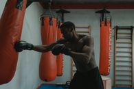 Man in Black Shorts and Red Boxing Gloves