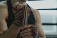 Woman in Black Tank Top Holding Multi Colored Necktie